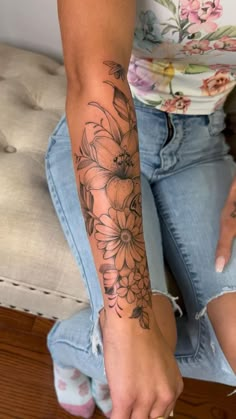 a woman with a flower tattoo on her arm