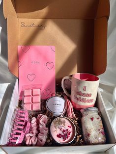 an open box with some pink items in it