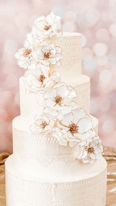 a wedding cake with white flowers on top