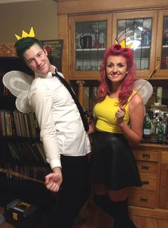 two people dressed up as tinkerbells and the man is wearing a yellow shirt