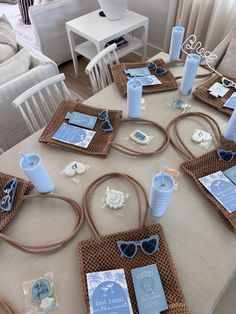 the table is set with blue and white items for an ocean themed bridal party