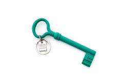 a green keychain with a metal tag hanging from it's side on a white background