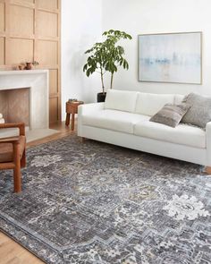 a living room with a white couch and rug