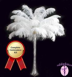 a white feather palm tree with a red ribbon around it's neck and the words complete centerpiece kit