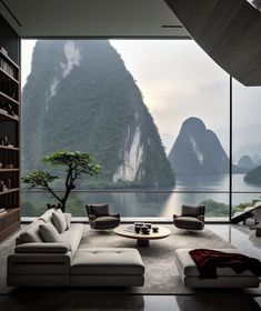 a living room filled with furniture next to a large window covered in mountain view overlooking the ocean