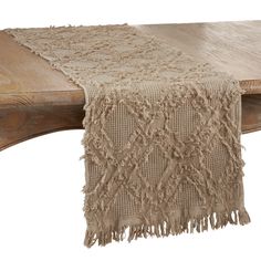 a wooden bench with a table runner on it's end and a white background