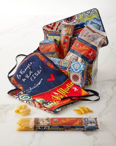 an assortment of snacks and pasta on a marble surface