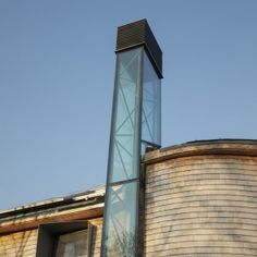 a tall tower with a clock on the side of it next to a brick building