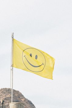 a yellow flag with a smiley face drawn on it