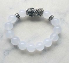 Hetian White Jade with S999 Silver Retro Pixiu & Six Mantra Charm Bracelet  Bead Size: 12mm (approx) Pixiu Size: 27 x W13 x H11mm (approx) White jade has the capacity to bring down your own thoughts, actions, and emotions. It'll also help in ridding yourself of negative thoughts and negative energies. This stone may also bring serenity, luck, and peace. Pixiu (貔貅) have always been regarded as Feng Shui auspicious celestial animal that possessed mystical powers capable of drawing and attracting C Bracelet Bead, White Jade, Be Natural, Bead Charm Bracelet, Negative Thoughts, Color Shades, Crystals And Gemstones, Accessories Bracelets, Feng Shui