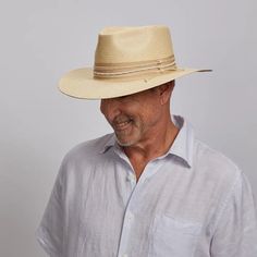 Corinth | Mens Wide Brim Straw Fedora Hat blends style and function with lightweight 100% firm Toyo straw construction. Its 3 1/2” wide brim provides ample sun protection, while the 1.5" ribbon trim with waxed rope and leather overlay adds a refined touch. Perfect for staying cool and sophisticated in sunny weather. Material: Lightweight 100% Firm Toyo Straw Shape: Outback Trim: 1.5" Ribbon Band with Knotted Waxed Rope and Cord Overlay Brim Size: 3 1/2" Crown Height: 4 1/2" Sweatband: AHM Velcro Classic Natural Fedora, White Flat Brim Fedora In Toquilla Straw, Beach Season Fedora With Upf 50+ In Toquilla Straw, Toquilla Straw Fedora With Upf 50+ And Curved Brim, Upf 50+ Brimmed Toquilla Straw Fedora, Lightweight Straw Fedora Hat, One Size, Leather Cowboy Hats, American Hat Makers, Straw Fedora Hat