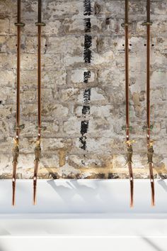 an old brick wall with metal rods sticking out of it