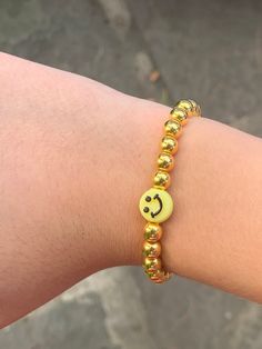 Gold Beaded Bracelet with Yellow Smiley Face! Fits all! Affordable Cute Smiley Face Beaded Bracelets, Cheap Yellow Beaded Bracelet With Smiley Face, Yellow Beaded Bracelets With Smiley Face, Casual Gold Beaded Charm Bracelet, Casual Gold Beaded Bracelets For Party, Gold Beaded Bracelet, Yellow Smiley Face, Gold Bead Bracelets, Smiley Faces