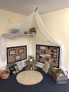 a room with several pictures on the wall and a round rug in front of it