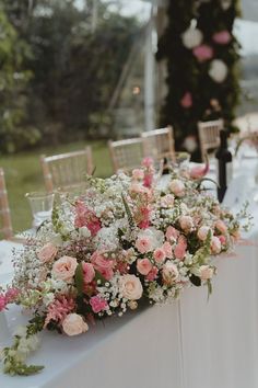 a table topped with lots of pink and white flowers