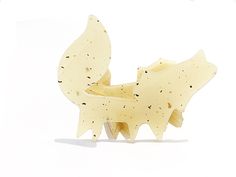 a piece of cheese that is shaped like a dog's head and tail, on a white background