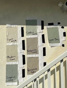 several different shades of paint on the side of a building with white balconies