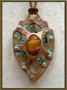 Copper and agatetized, fossilized shell reliquary pendant. Spiritual Bronze Agate Jewelry, Artisan Amber Cabochon Necklace, Antique Brown Agate Jewelry, Amber Cabochon Artisan Necklace, Artisan Brown Medallion Jewelry, Unique Amber Color Brass Jewelry, Brown Artisan Medallion Jewelry, Unique Handmade Rust-colored Jewelry, Amber Amulet Style Jewelry With Natural Stones