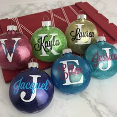 six personalized christmas ornaments in different colors