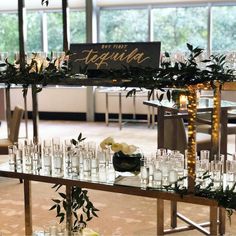 a long table filled with lots of glasses and candles on top of eachother