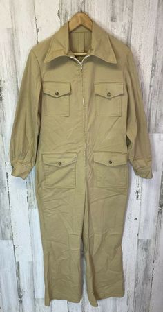 Good preowned vintage condition. There are no tags. Please see measurements in pictures. Not sure if mens or women’s. Seems like it could be for either. Zip front. Pockets on front. Big collar. Please see all pictures for details. Thanks for looking! Retro Spring Workwear Overalls, Retro Workwear Jumpsuits And Rompers, Retro Style Workwear Overalls And Rompers, Vintage Overalls For Fall Workwear, Vintage Cotton Jumpsuits And Rompers For Work, Vintage Spring Workwear Overalls, Retro Fall Jumpsuits And Rompers With Pockets, Retro Jumpsuits And Rompers With Pockets For Fall, Vintage Long Sleeve Jumpsuits And Rompers For Work