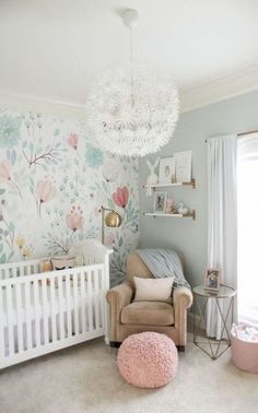 a baby's room with a white crib and floral wallpaper on the walls