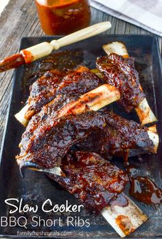 slow cooker bbq short ribs on a plate with barbecue sauce and toothpicks