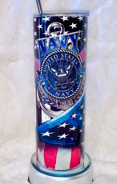 an american flag tube holder with a patriotic design on the top and bottom is holding a straw in it