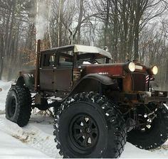 an old truck is parked in the snow