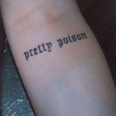 a person with a tattoo that reads pretty poison on their left arm and the word pretty poison written in cursive font