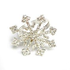 a snowflake shaped ring on a white background