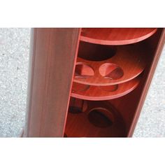 a close up of a wooden cabinet with many items in it