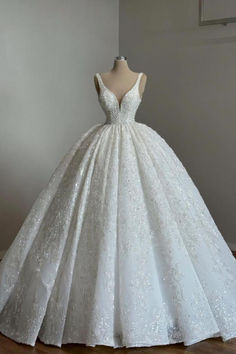 a white wedding dress on display in a room