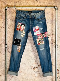 a pair of jeans with patches and skulls on them