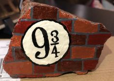 a piece of art made to look like a brick wall with the number 9 on it