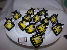 there are many small yellow and black decorations on the plate