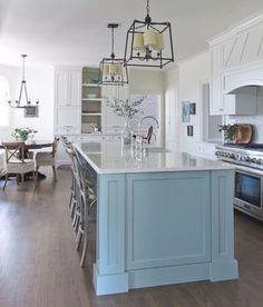 a large kitchen with an island in the middle