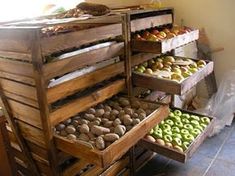 an assortment of different types of doughnuts and pastries on display in wooden crates