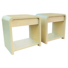 two white side tables sitting next to each other