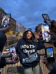 a group of people holding up their cell phones