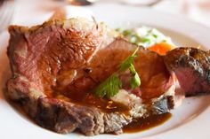 a white plate topped with meat and vegetables