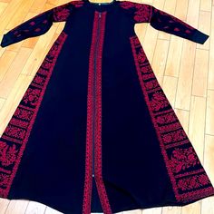 Size 1 Tatreez Thobe With Tag Red Embroidered Long Sleeve Abaya, Black Fitted Floor-length Kaftan, Red Fitted Floor-length Kaftan, Red Dabka Embellished Long Sleeve Kaftan, Red Long Sleeve Dabka Kaftan, Red Long Sleeve Kaftan With Dabka, Fitted Red Kaftan For Eid, Red Fitted Kaftan For Eid, Fitted Red Long Sleeve Kaftan