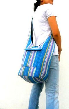 "This Beautiful Light Blue Multi color Bag This is a convenient very comfortable colorful bag and suitable for everyone. Multi color Light Blue Cross Body Shoulder Bag Top zipper closure with Front zipper pocket This bag is fully black lined interior This bag is 100% cotton Measurements Size (Approx): Length: 15\" Height: 17\" Width: 7\" Strap Drop: 45\" Color : Multi color Light Blue Please Visit our store: https://www.etsy.com/shop/Avivahandmade Thank You For Watching" Bohemian Beach Bag For Mobile Phone, Bohemian Mobile Phone Bag For The Beach, Bohemian Style Mobile Phone Bag For Beach, Bohemian Beach Mobile Phone Bag, Handmade Hippie Hobo Bag For Travel, Hippie Handmade Hobo Bag For Travel, Bohemian Pouch Bucket Bag For Everyday Use, Bohemian Style Pouch Bucket Bag For Everyday Use, Bohemian Bucket Bag For Everyday Use