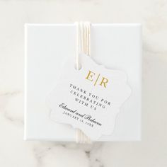 a white box with a tag on it that says, e / r thank you for celebrating with us