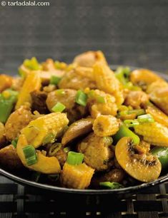 a black bowl filled with food on top of a table