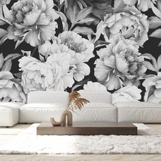 a black and white floral wallpaper mural in a living room with a large couch