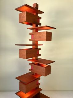 a tall wooden sculpture sitting on top of a table