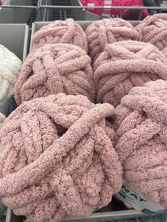 several pink towels are stacked in a basket