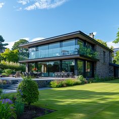 a large house sitting on top of a lush green field