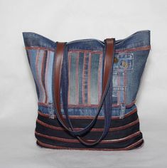 "This beautiful, handmade bag is crafted from small pieces of old denim. It can be worn either on your shoulder or as a handbag and has enough room to store all of your essentials. It features two pockets for small items, one with a zipper closure for extra security, and a key ring. The bag closes securely with a magnetic button and can be hand washed and dried in the sun. SIZE: Height: 37cm (14.50\") Width:  40cm  (15.54\") Depth:  12cm   ( 4.72\") Length of handles: 62cm (24.10\") Each piece that you will find in the collection is made one at a time, with carefully selected materials, and most styles are created in very small runs according material availability. Handmade in our Most na Soci studio - Real colors may differ slightly from their appearance on your display. - Handmade items Denim Bags, Recycle Bag, Jeans Bag, Handmade Bag, Denim Bag, Medium Bags, Sewing Inspiration, Handmade Bags, Medium Size